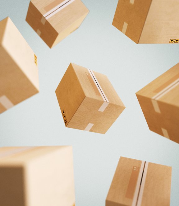 Multiple cardboard shipping boxes suspended in mid-air against a light blue background, creating a sense of motion and logistics flow.