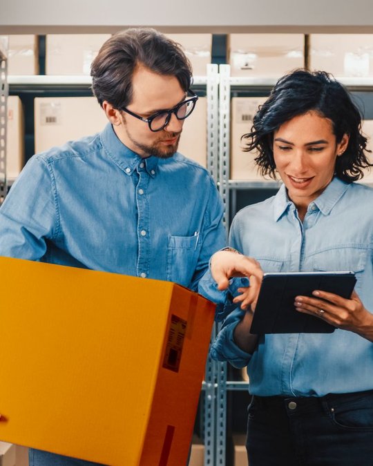 People in operations checking parcel details zoomed