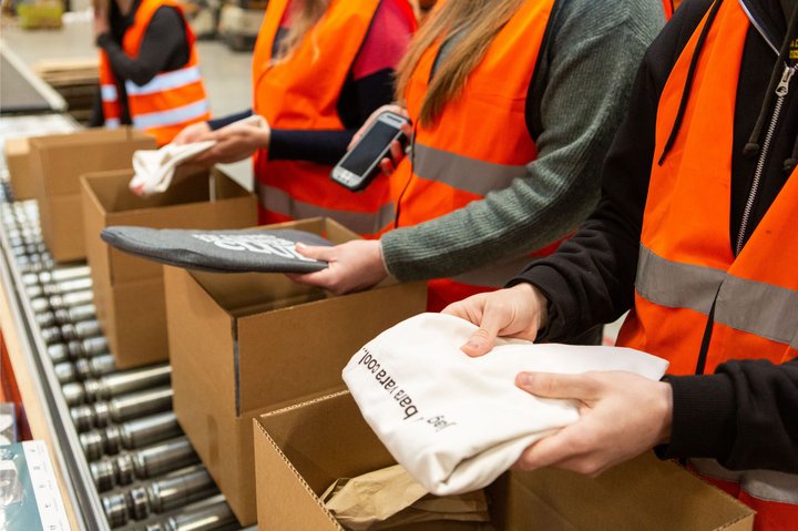 4 Operations workers pack prepare orders.