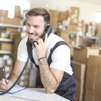 iStock - Jan 2021 - man on phone in warehouse - medium business - parcel - packing